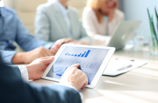 Cropped shot of a group of businesspeople looking at graphs on digital tablets